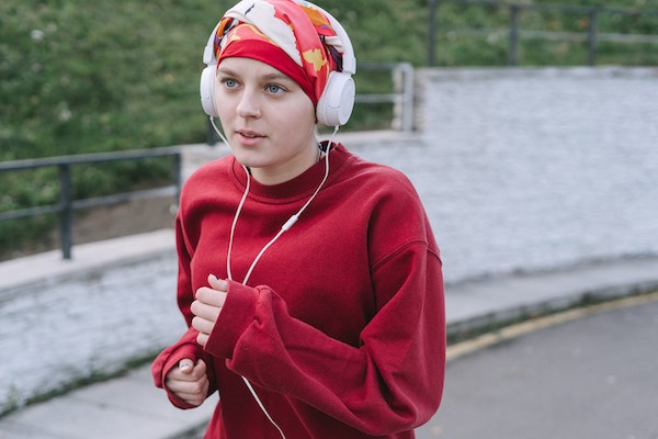 Integrative medicine exercise Woman running with headphones on